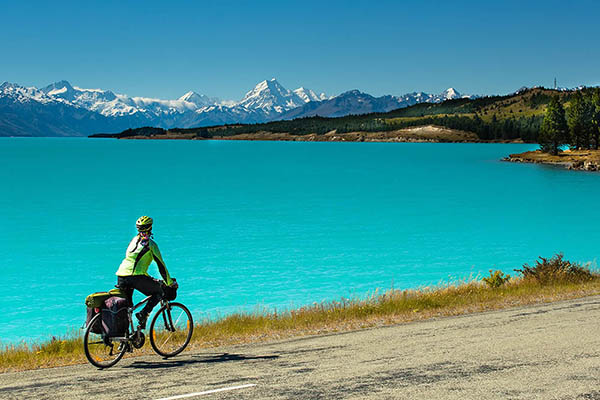 Biking the mountain road along Lake Pukaki. View from Glentanner Park Centre near Mount Cook