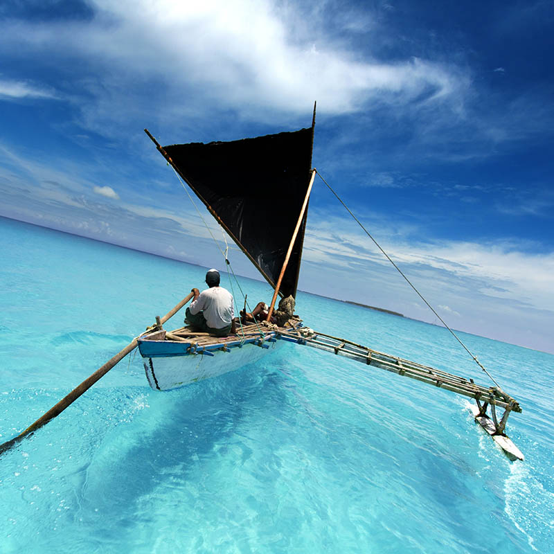 Traditional boat sailing in a tropical lagoon