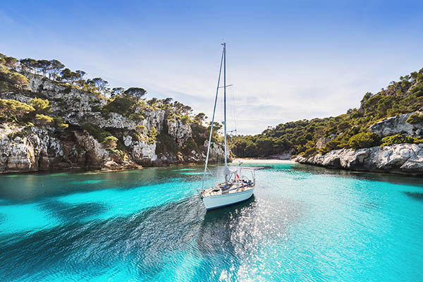 Sailing off Cala Macarelleta, Menorca island, Spain