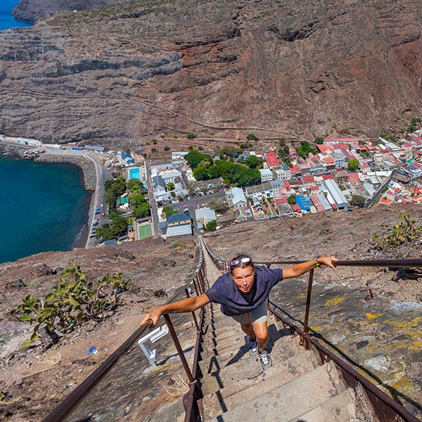 woman climbing up the steep Jacobs ladder in Jamestown, capital of St. Helena Island, south atlantic