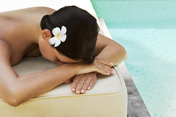 Woman waiting for a spa treatment in a tropical lagoon