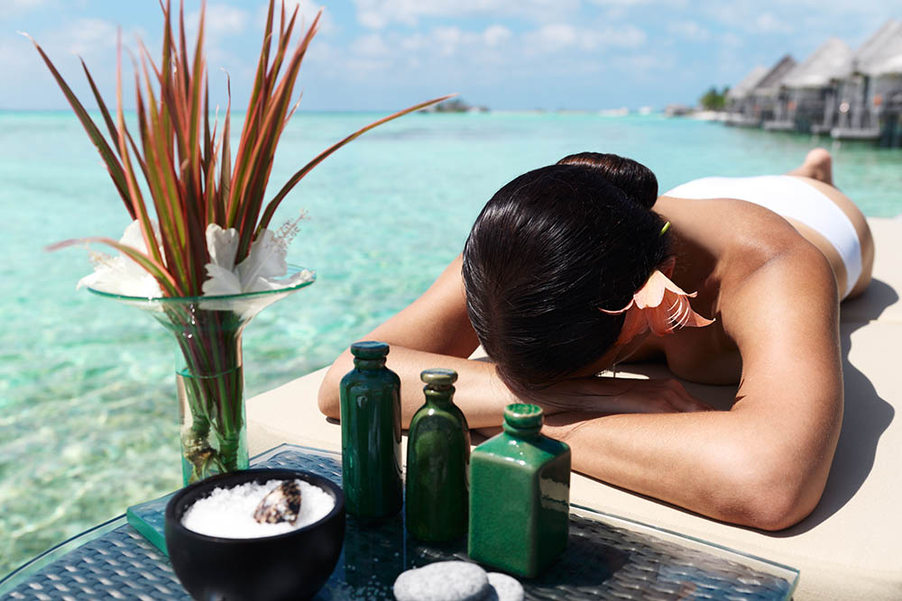 Woman waiting for a spa treatment in a tropical lagoon