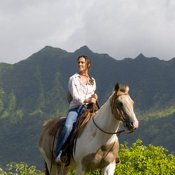 Woman horse riding on the island of Kauai, Hawaii