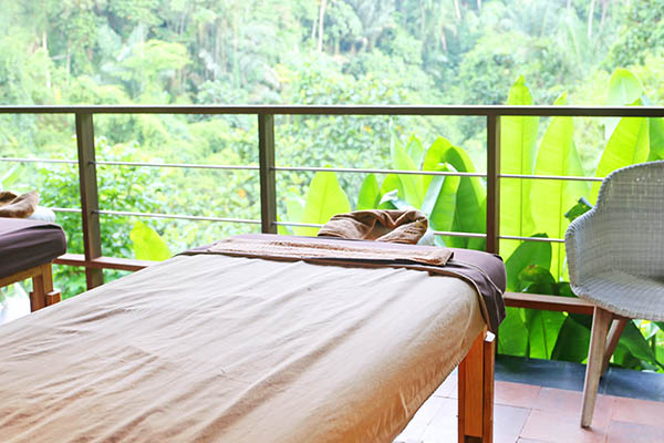 Open air spa massage room in tropical setting