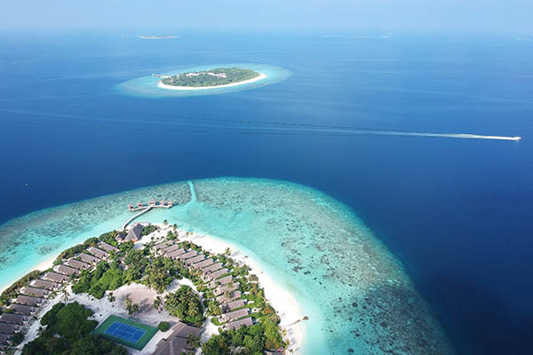 Aerial view of a resort in the Maldives showing a tennis court