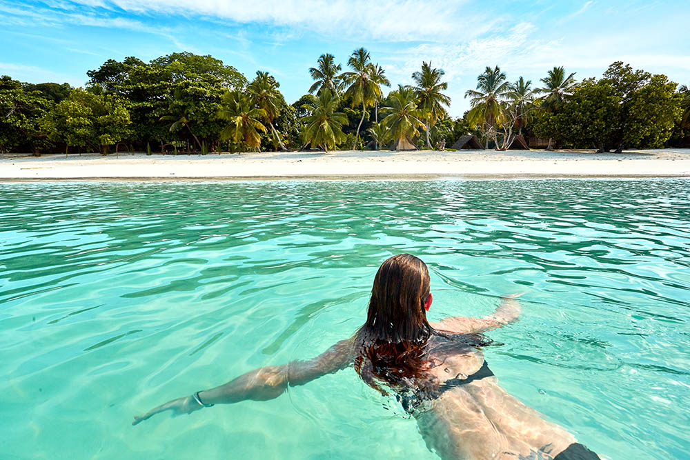 Woman swimming at the beach on Nosy Iranja, Madagascar