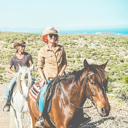 Couple riding horses in countryside