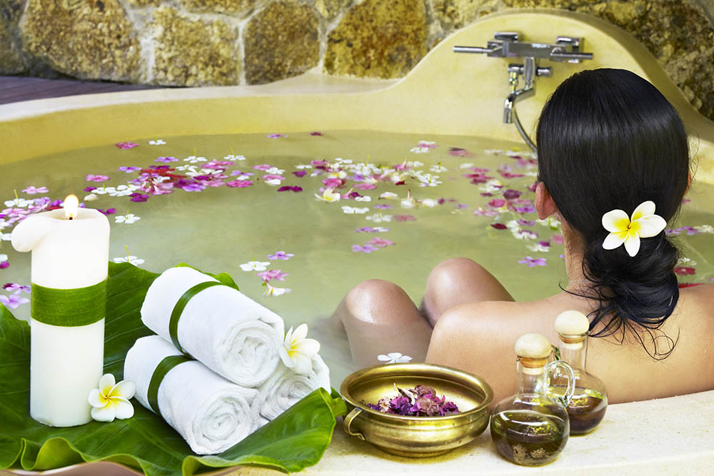 Woman sitting in a luxury spa bath