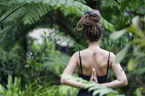 Woman practicing yoga in the jungle