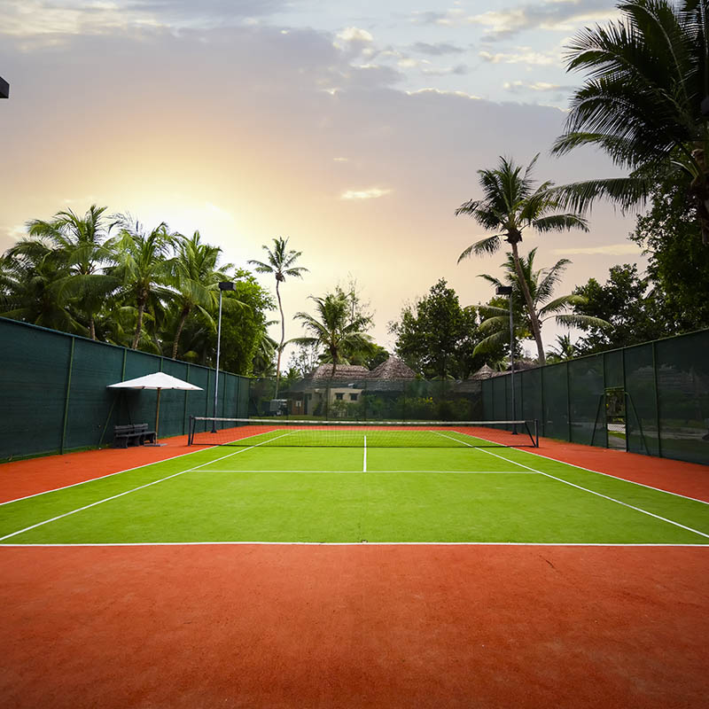 Outdoor tennis court in a tropical setting