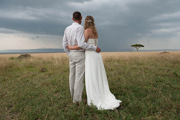 wedding couple standing in a field