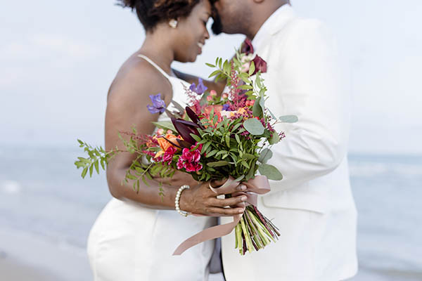 African American couple getting married at the beach