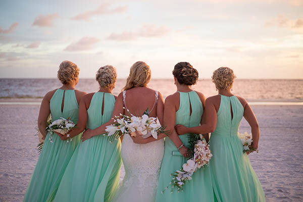 Beautiful Bride and Bridesmaids in Wedding Party Looking out at