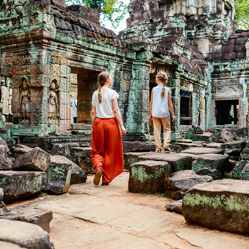 Family visiting ancient Preah Khan temple in Angkor Archeological area in Cambodia