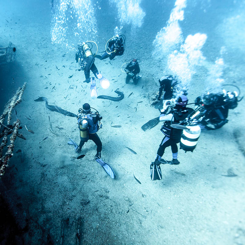 Scuba divers exploring a wreck cargo ship at Vis, Croatia