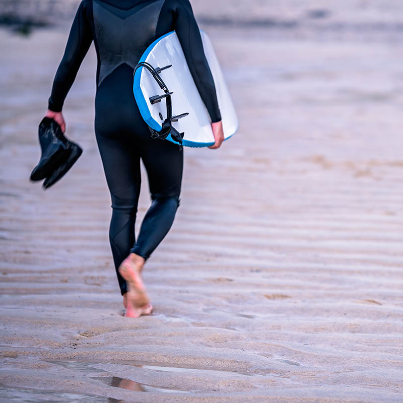 Surfer on the beach at Saint Ives, Cornwall