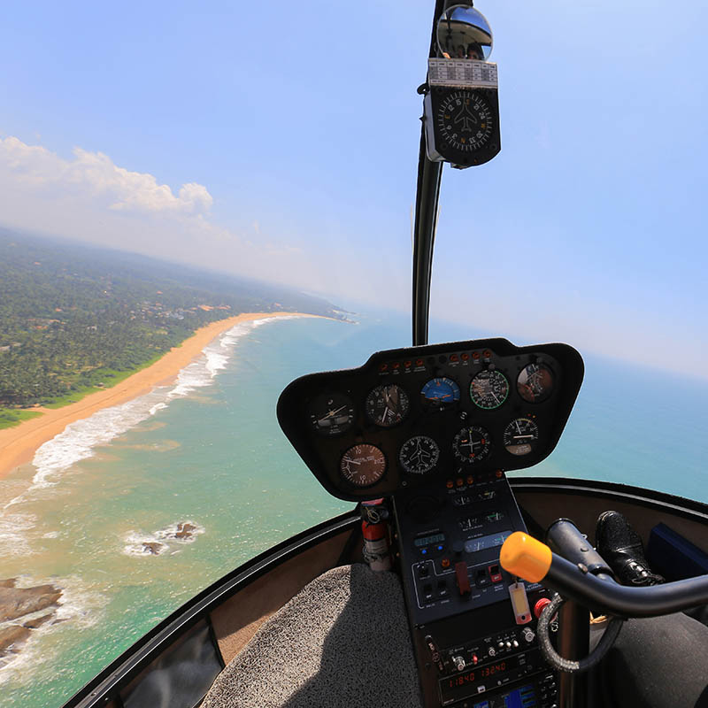 Helicopter flying over a tropical beach in Sri Lanka