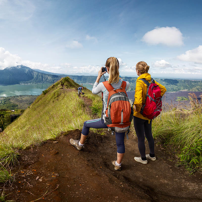 Two hikers walking on the caldera of volcano of Batur, Bali, Indonesia