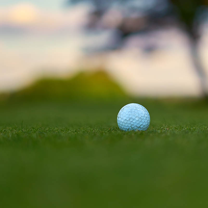 Close up of a golf ball at sunset