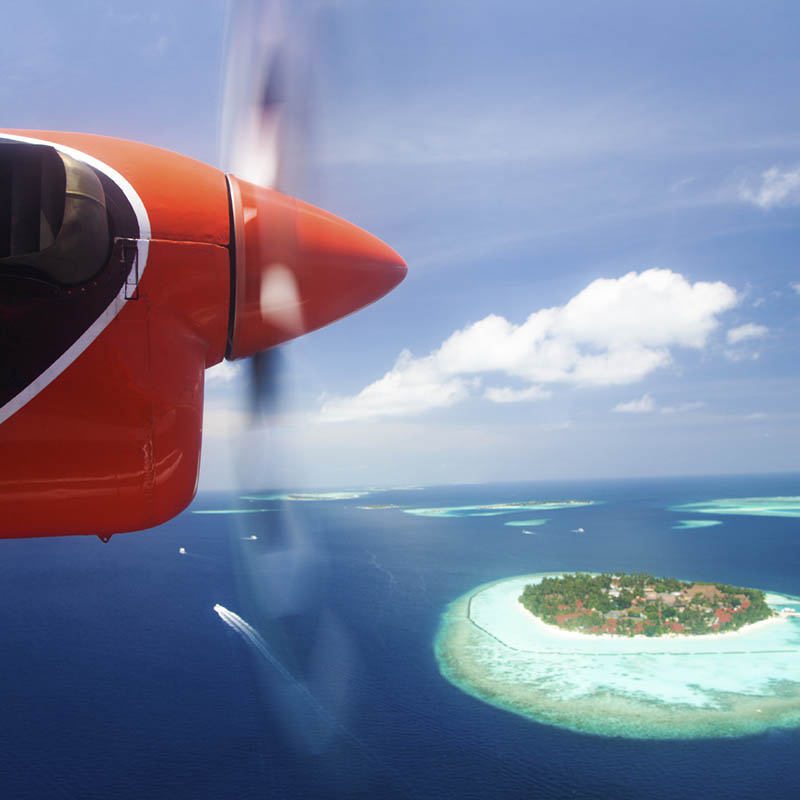 Seaplane flying over an island in the Maldives