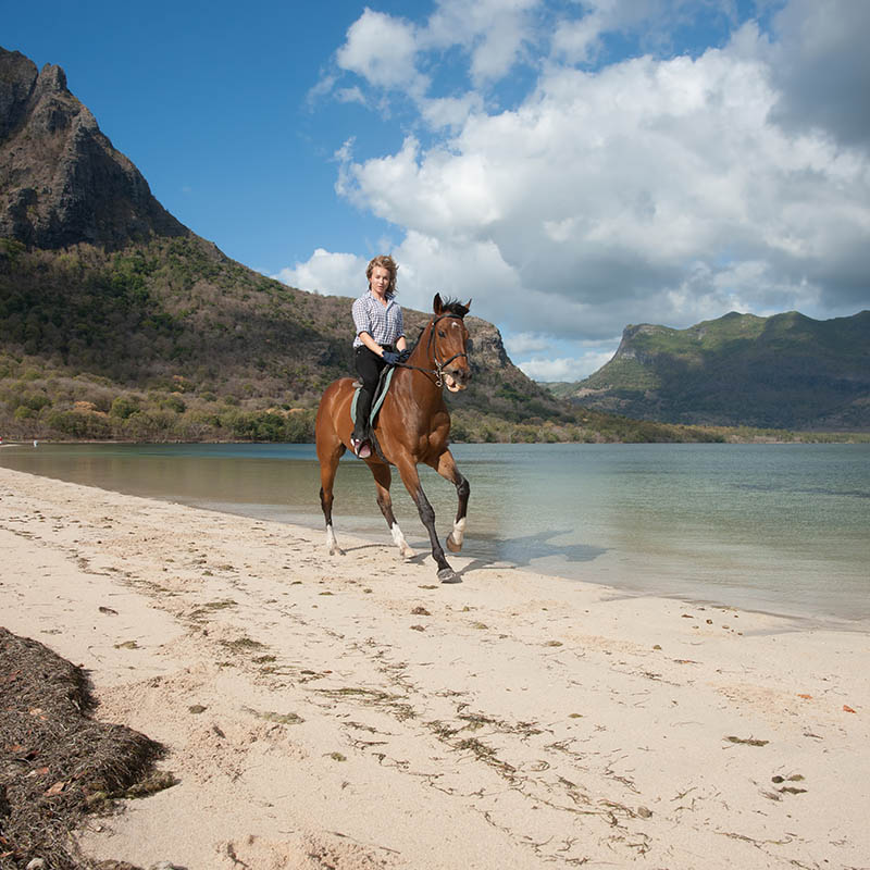 Horse riding along a beach on Mauritius