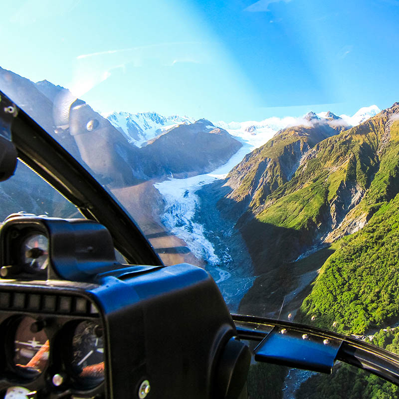 View from the cockpit of a helicopter as it flies over the Fox Glacier on New Zealand's south island