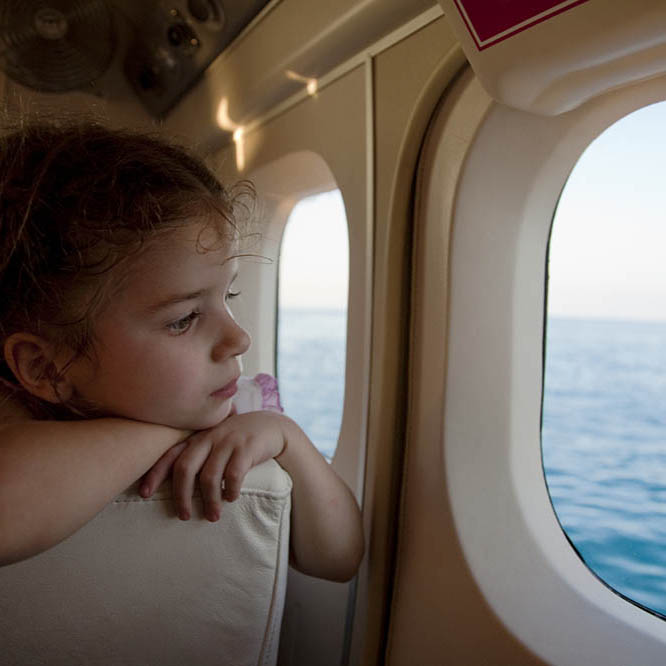 young girl looking out of a small aircraft