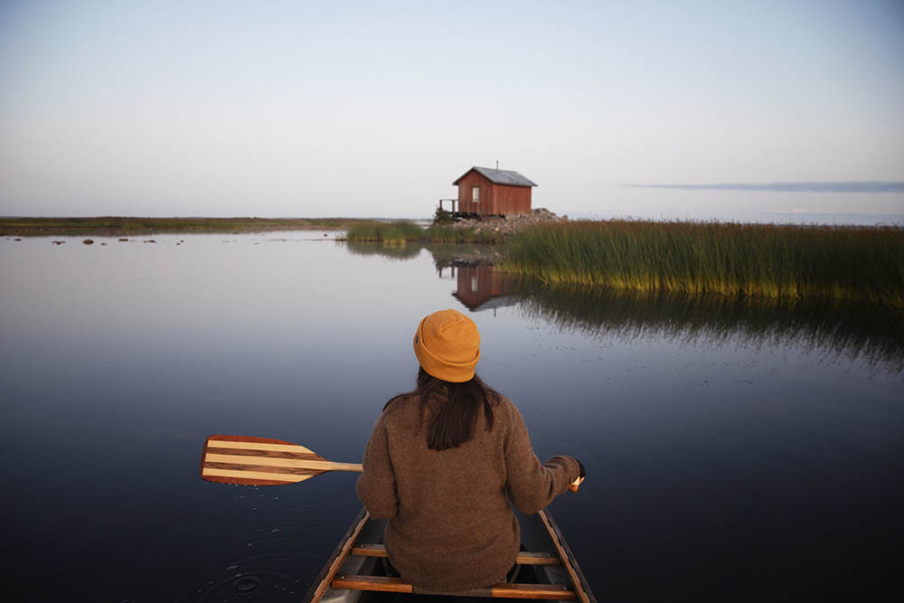 Woman rowing a boat in Finland