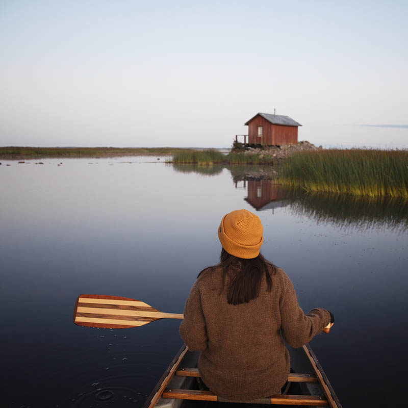 Woman rowing a boat in Finland