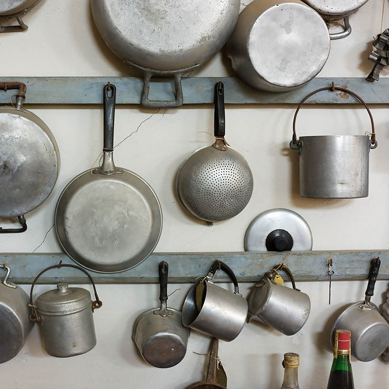 Vintage pots and pans hanging on a wall