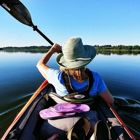 Woman kayaking on a lake in Ireland