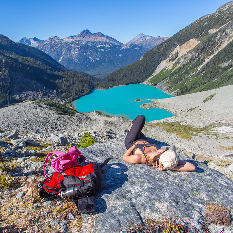 backpacker is resting after along hike in Canadian rockies