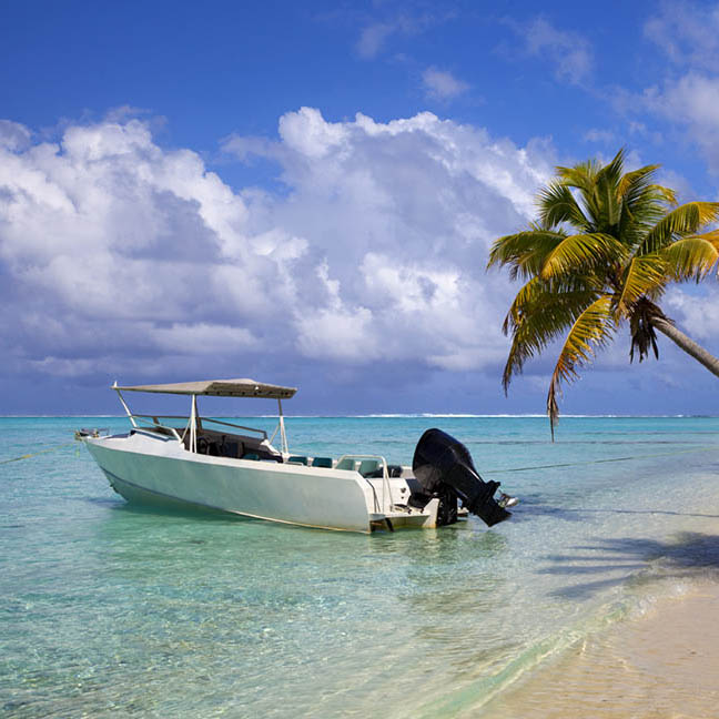 Boat moored off a beach in the Cook Islands