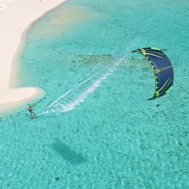 Aerial view young man kitesurfing in the Aitutaki Lagoon, Cook Islands