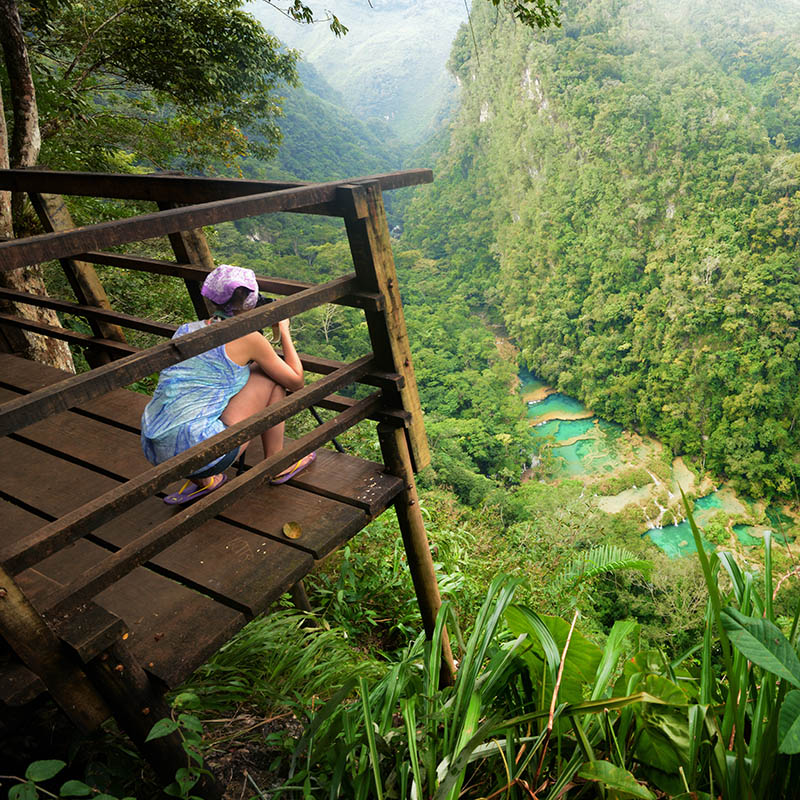 Photographer on the lookout point on the Cascades National Park in Semuc Champey, Guatemala