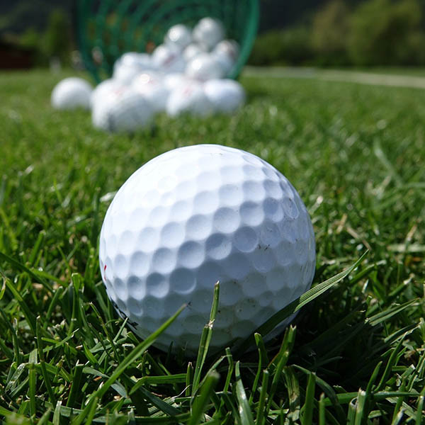 Close-up of golf balls on a driving range