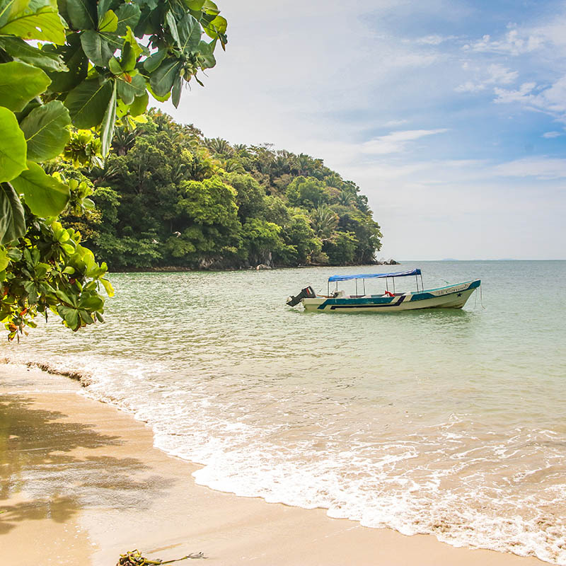 Boat in secluded bay, Punta Sal and Janette Kawas National Park, Tela, Honduras