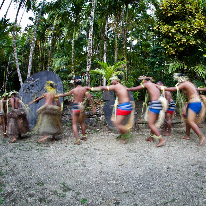 Villagers perform traditional dances in front of a stone money bank in Yap, Micronesia