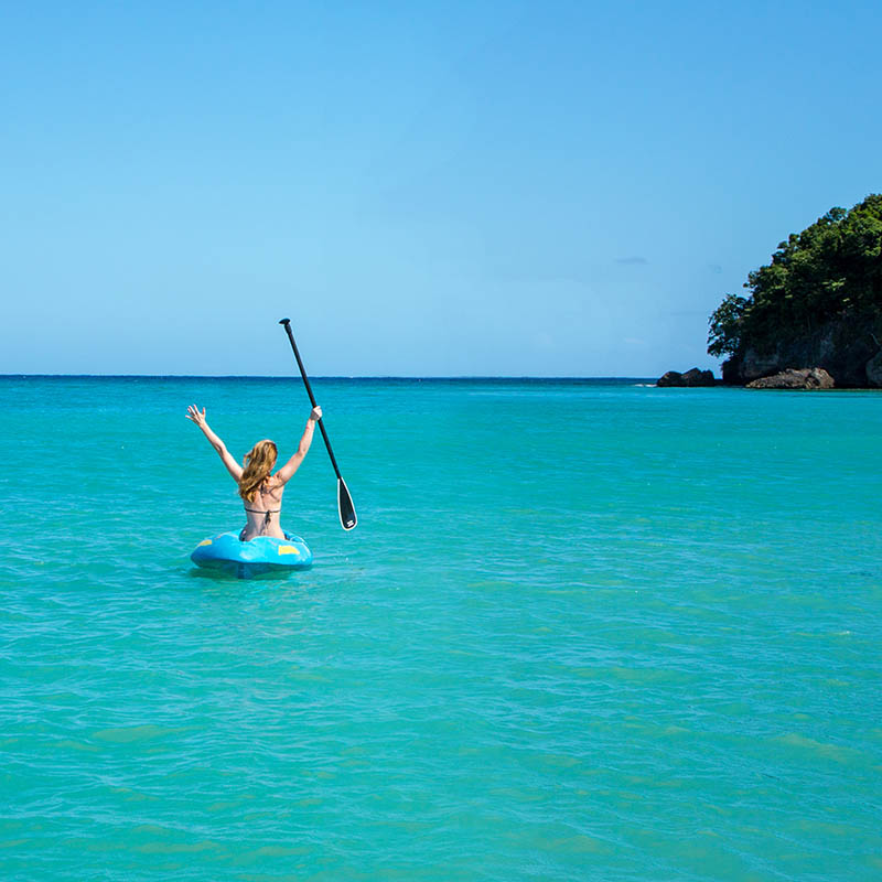 Woman kayaking on a turquoise ocean