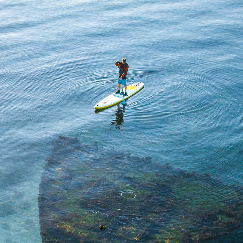 Man on SUP and sunken ship