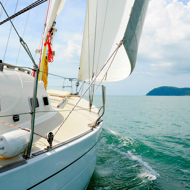 Yacht sailing off a tropical island