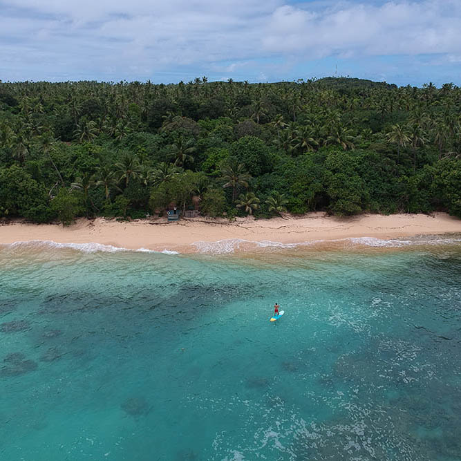 Paddleboarding off an isolated island in Tonga