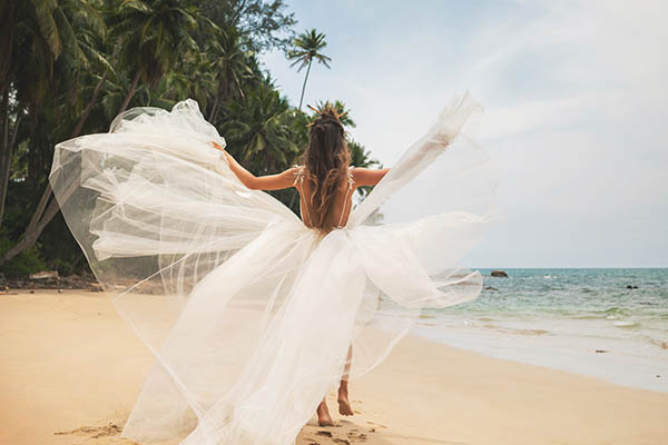 Back view of a bide on a tropical beach