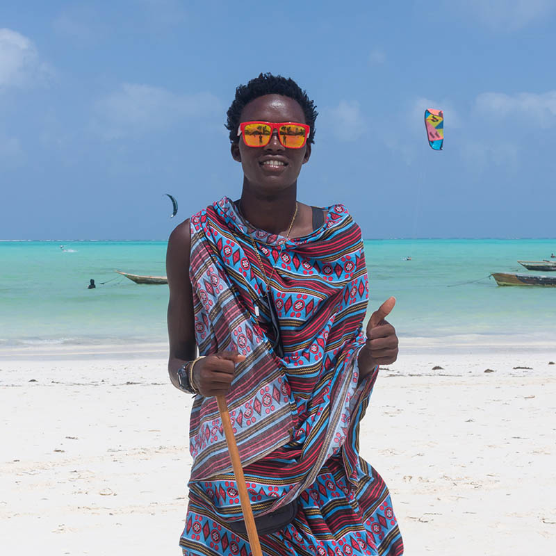 Traditionally dressed black man on a tropical beach