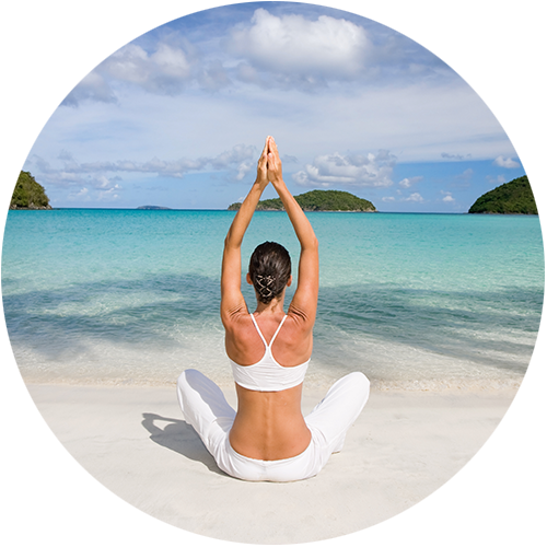 Woman on a beach in yoga position