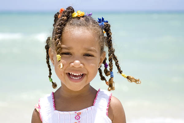 Close up of a pretty Afro American young girl by the sea