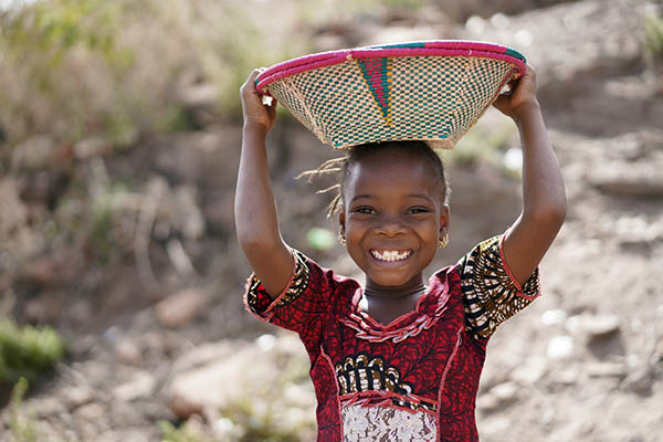 African Young Girl Carrying Food Basket