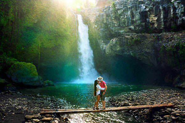 Honeymoon couple at Tegenungan waterfall on the island of Bali, Indonesia