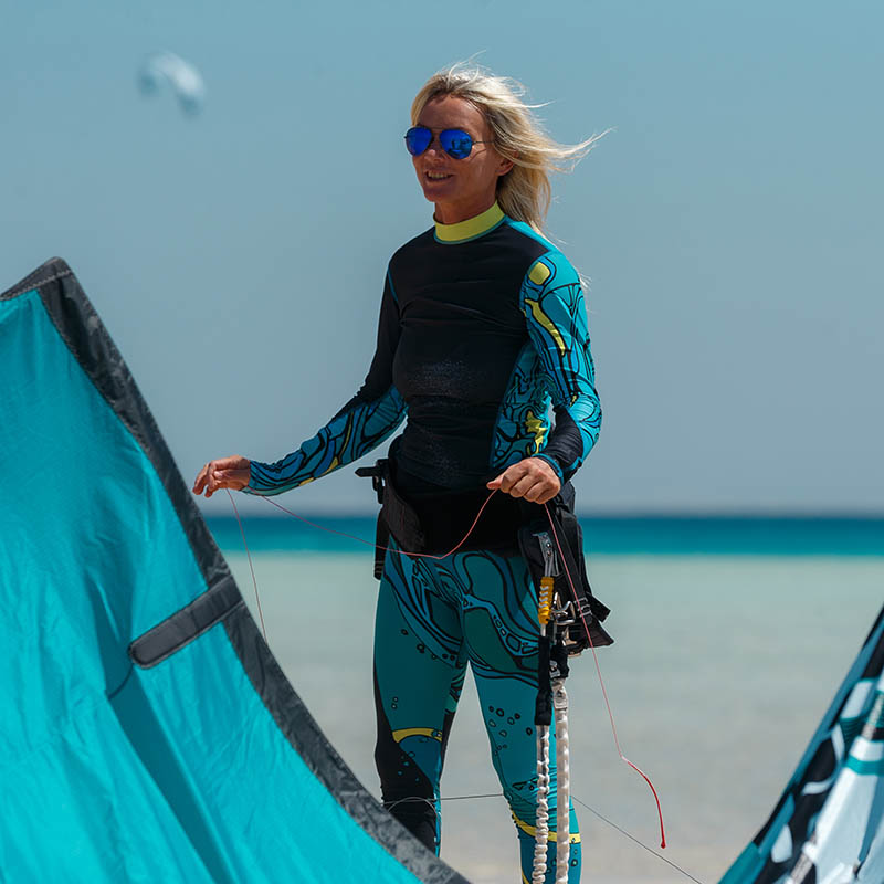 Kitesurfing girl on a tropical beach