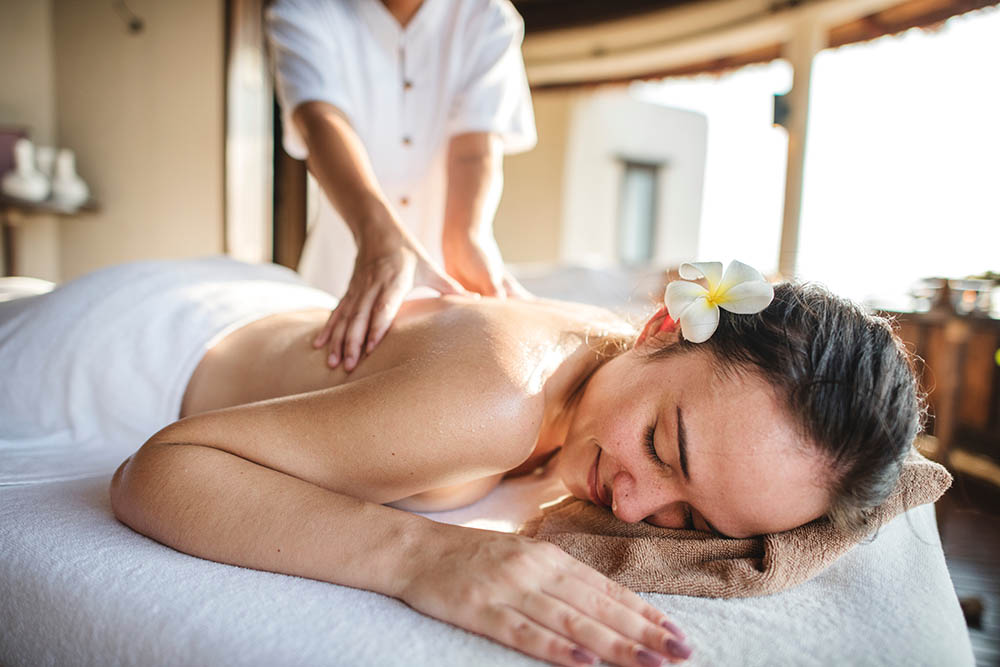 Woman relaxing with a herbal massage